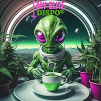 a green alien sitting at a table with a cup of coffee